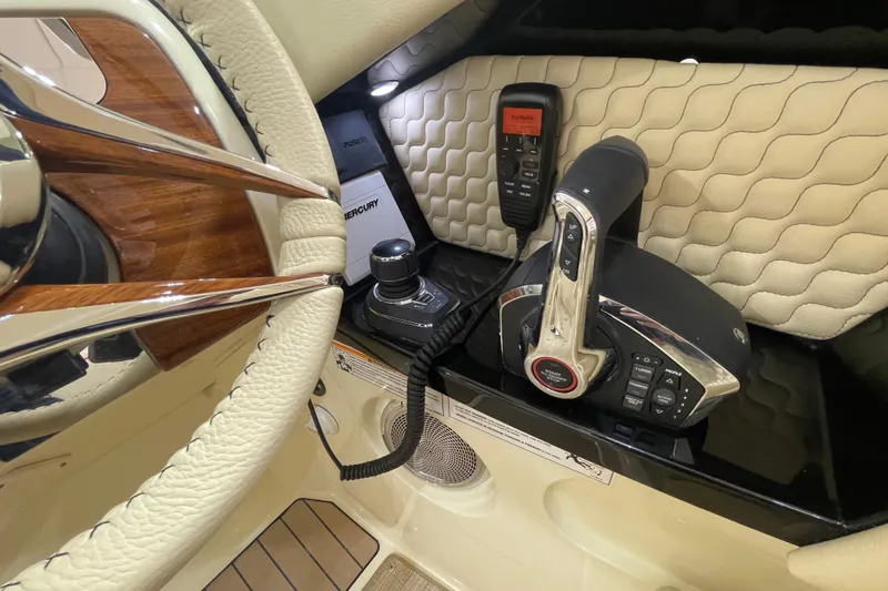 Slide: The Image of 2026 Chris-Craft Launch 31 GT steering wheel and control panel close-up. - 35