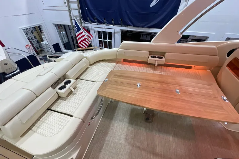 Slide: The Image of 2026 Chris-Craft Launch 31 GT interior with beige seating and wooden table. - 52
