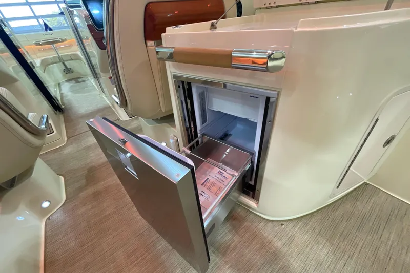 Slide: The Image of 2026 Chris-Craft Launch 31 GT interior with open stainless steel drawer fridge. - 57