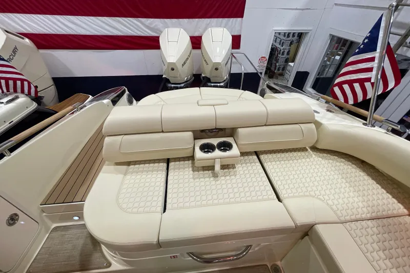 Slide: The Image of 2026 Chris-Craft Launch 31 GT boat interior with beige seating and American flag. - 64