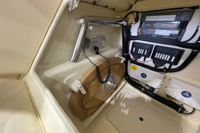 Slide: The Image of 2026 Chris-Craft Launch 31 GT interior showing electrical panel and storage area. - 7