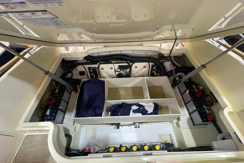 Slide: The Image of Engine compartment of 2026 Chris-Craft Launch 31 GT, showcasing organized storage and battery setup. - 72