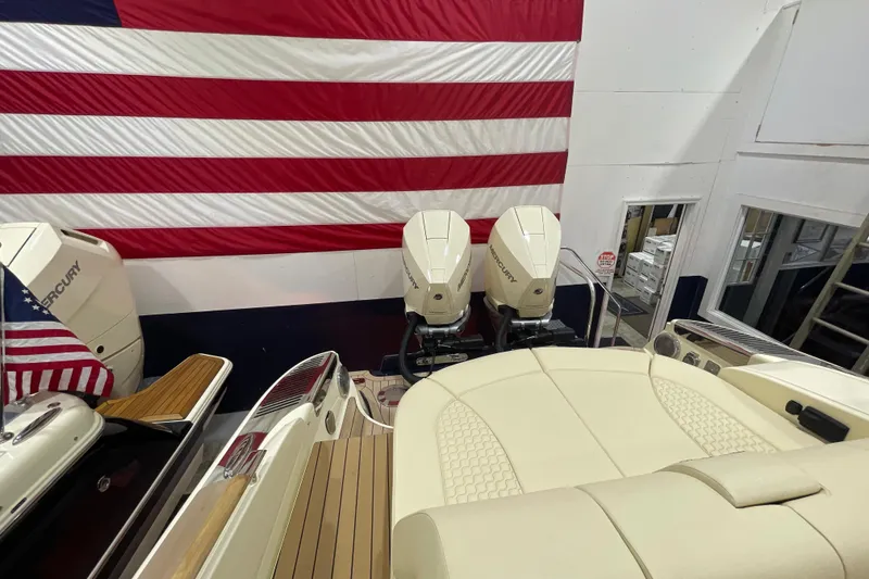 Slide: The Image of 2026 Chris-Craft Launch 31 GT boat with Mercury engines, American flag backdrop. - 74
