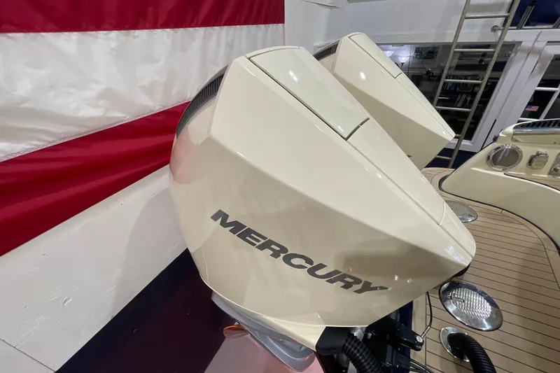 Slide: The Image of 2026 Chris-Craft Launch 31 GT with dual Mercury outboard engines, docked near American flag. - 77