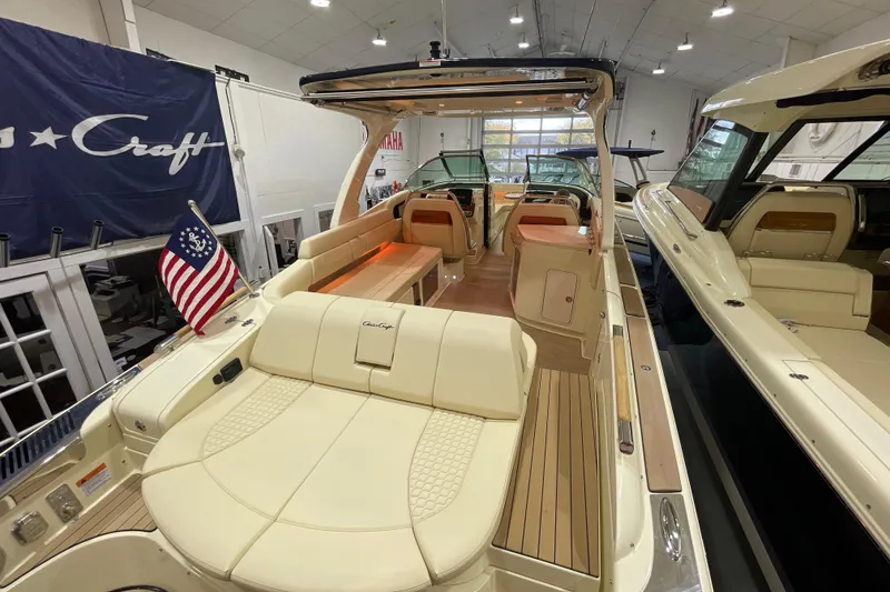 Slide: The Image of 2026 Chris-Craft Launch 31 GT luxury boat interior with American flag, showcased indoors. - 79