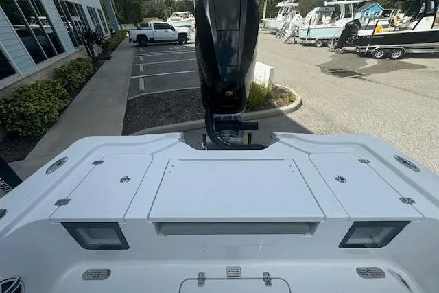 Slide: The Image of 2025 Sportsman Masters 267OE Bay Boat, rear view, parked in a marina lot. - 10