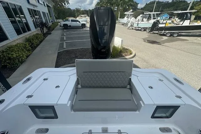 Slide: The Image of 2025 Sportsman Masters 267OE Bay Boat, rear view with seating and engine, parked outdoors. - 11
