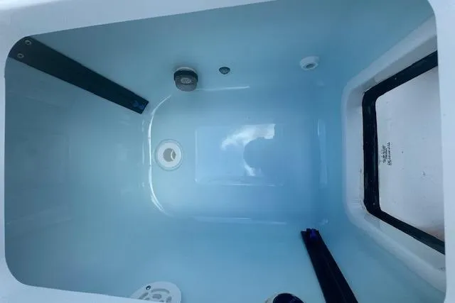 Slide: The Image of 2025 Sportsman Masters 267OE Bay Boat livewell interior, featuring a clean, spacious design. - 12