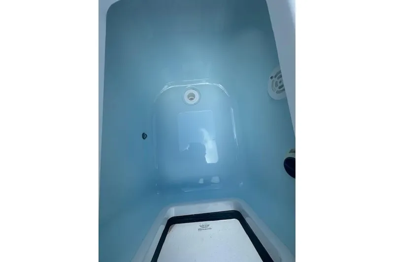 Slide: The Image of Livewell interior of 2025 Sportsman Masters 267OE Bay Boat, filled with water. - 13