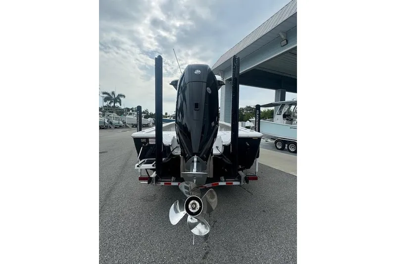 Slide: The Image of 2025 Sportsman Masters 267OE Bay Boat rear view with powerful outboard motor. - 17