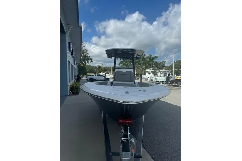 Slide: The Image of 2025 Sportsman Masters 267OE Bay Boat parked outdoors under a cloudy sky. - 19