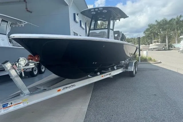 Slide: The Image of 2025 Sportsman Masters 267OE Bay Boat on trailer, parked outdoors. - 21