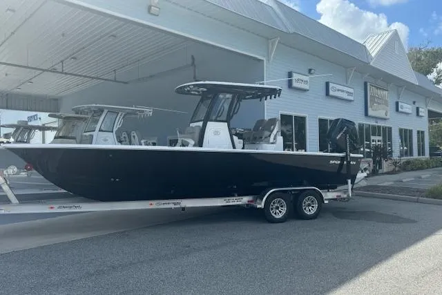 Slide: The Image of 2025 Sportsman Masters 267OE Bay Boat on trailer outside dealership. - 23