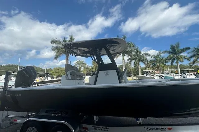 Slide: The Image of 2025 Sportsman Masters 267OE Bay Boat on trailer, palm trees in background. - 3