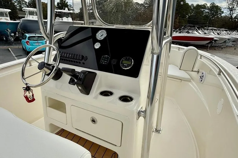 Slide: The Image of 2026 Bulls Bay 230 Center Console boat interior with steering wheel and control panel. - 10