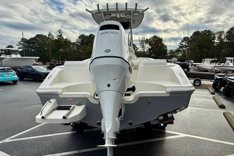 Slide: The Image of 2026 Bulls Bay 230 Center Console boat with powerful outboard motor in a parking lot. - 4