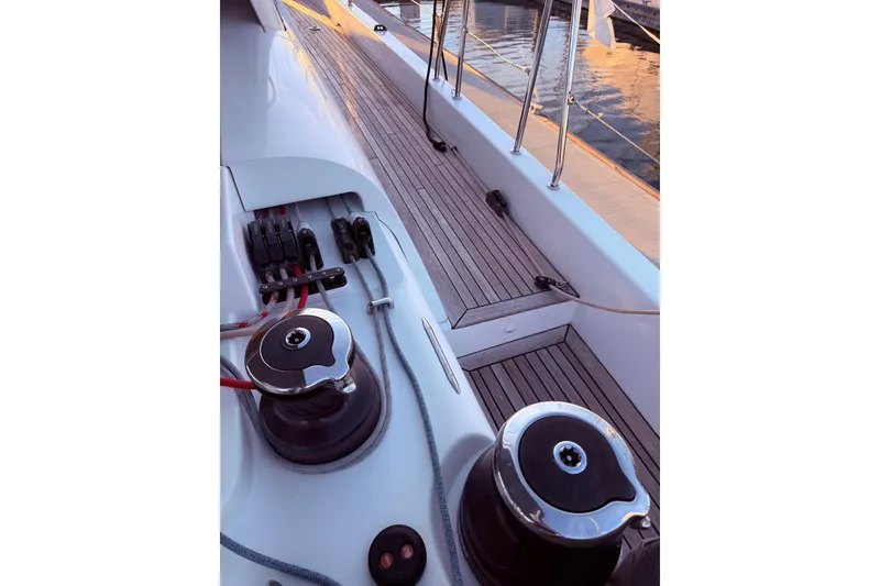 Slide: The Image of Deck view of 2022 Beneteau Oceanis Yacht 54, showcasing winches and teak flooring. - 13