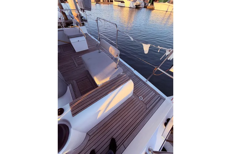 Slide: The Image of Deck of 2022 Beneteau Oceanis Yacht 54 with wooden flooring, docked at marina. - 14