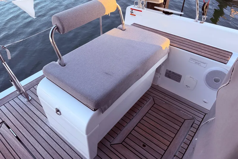 Slide: The Image of 2022 Beneteau Oceanis Yacht 54 deck with cushioned seating and wooden flooring. - 18