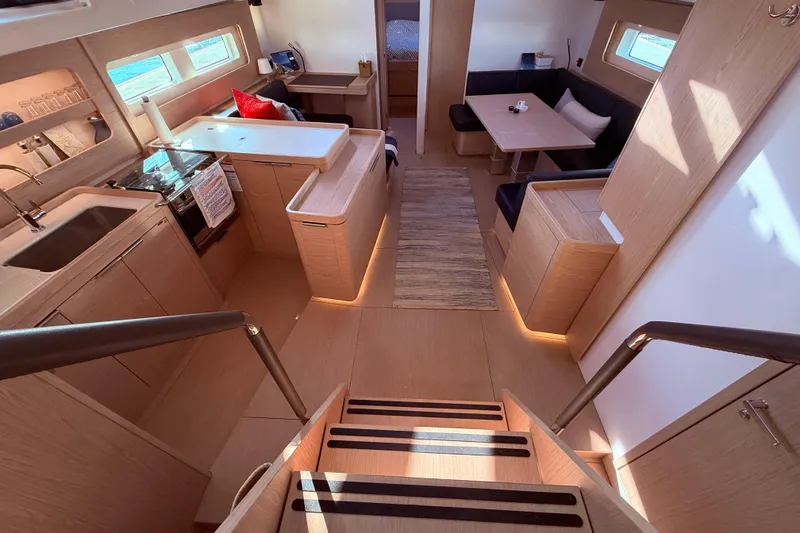 Slide: The Image of Luxurious interior of 2022 Beneteau Oceanis Yacht 54, featuring modern kitchen and seating area. - 28