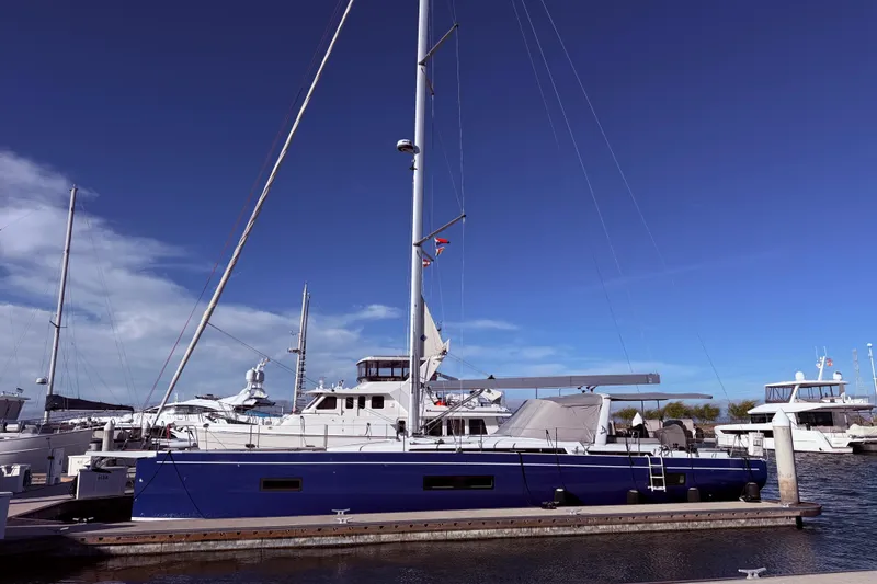 Slide: The Image of 2022 Beneteau Oceanis Yacht 54 docked at marina under clear blue sky. - 3