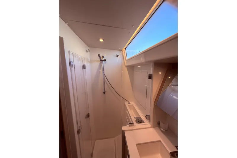 Slide: The Image of Modern bathroom interior of 2022 Beneteau Oceanis Yacht 54 with skylight and shower. - 43