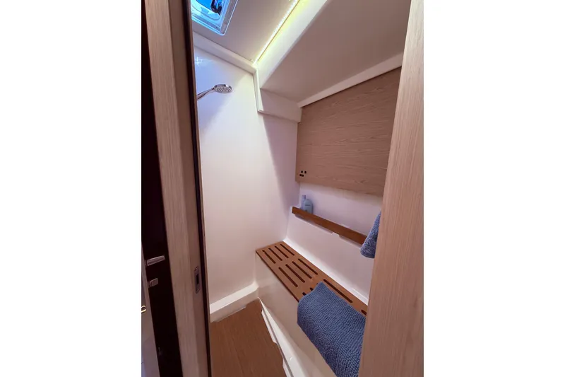 Slide: The Image of Interior shower area of 2022 Beneteau Oceanis Yacht 54, featuring wooden accents and modern design. - 51