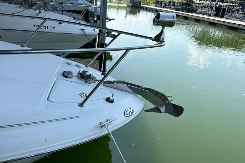 Slide: The Image of 2004 Sea Ray 260 Sundancer boat docked in calm marina waters. - 10