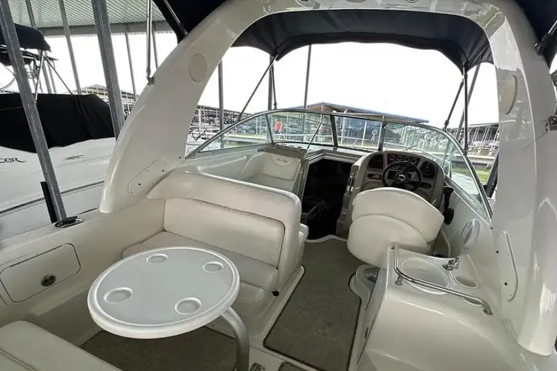 Slide: The Image of 2004 Sea Ray 260 Sundancer boat interior with seating and helm. - 16