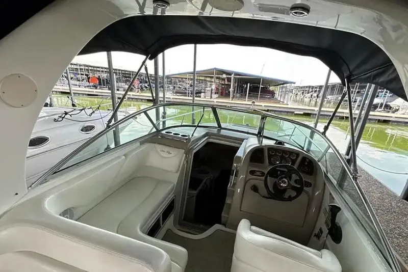 Slide: The Image of 2004 Sea Ray 260 Sundancer boat interior with helm and seating area. - 17