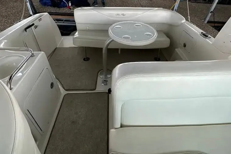 Slide: The Image of 2004 Sea Ray 260 Sundancer interior with seating and round table. - 18
