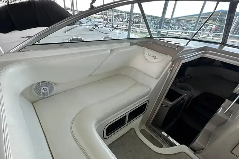 Slide: The Image of Interior view of 2004 Sea Ray 260 Sundancer boat with white seating and cabin entrance. - 20