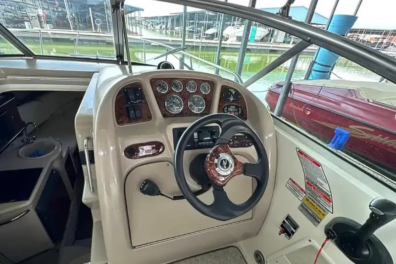 Slide: The Image of 2004 Sea Ray 260 Sundancer helm with steering wheel and instrument panel. - 22