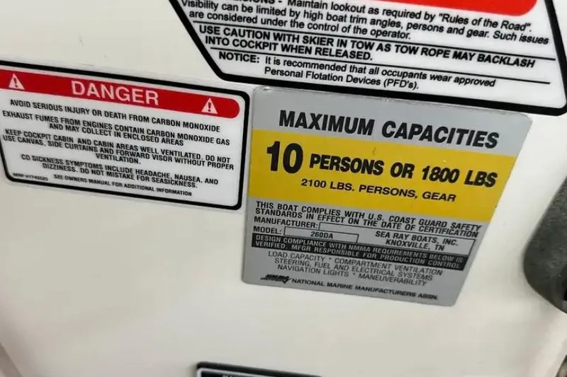 Slide: The Image of Warning labels on 2004 Sea Ray 260 Sundancer boat, indicating maximum capacity and safety precautions. - 23