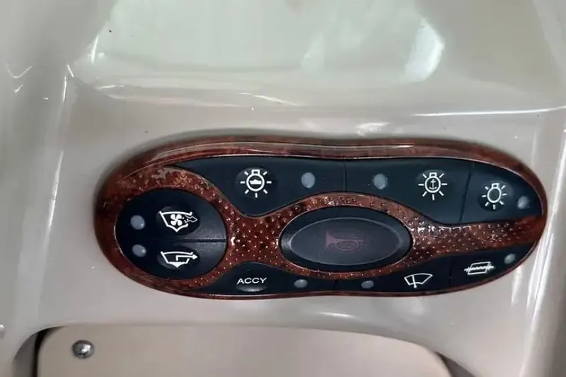 Slide: The Image of Control panel of a 2004 Sea Ray 260 Sundancer boat with various function buttons. - 25