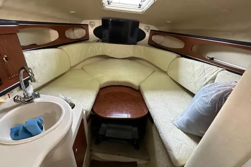 Slide: The Image of Interior of 2004 Sea Ray 260 Sundancer with cozy seating and compact sink area. - 31