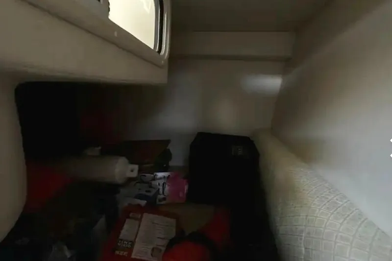 Slide: The Image of Interior cabin of 2004 Sea Ray 260 Sundancer with storage items. - 35