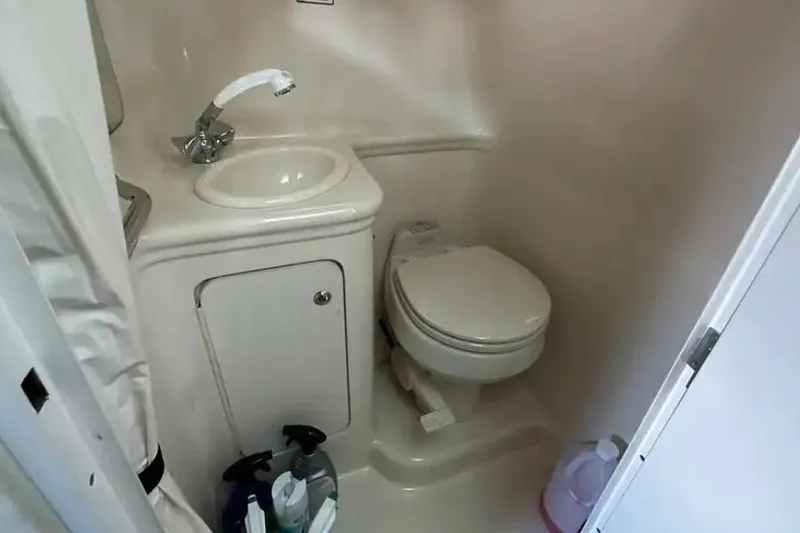 Slide: The Image of Compact bathroom in 2004 Sea Ray 260 Sundancer boat with sink and toilet. - 36