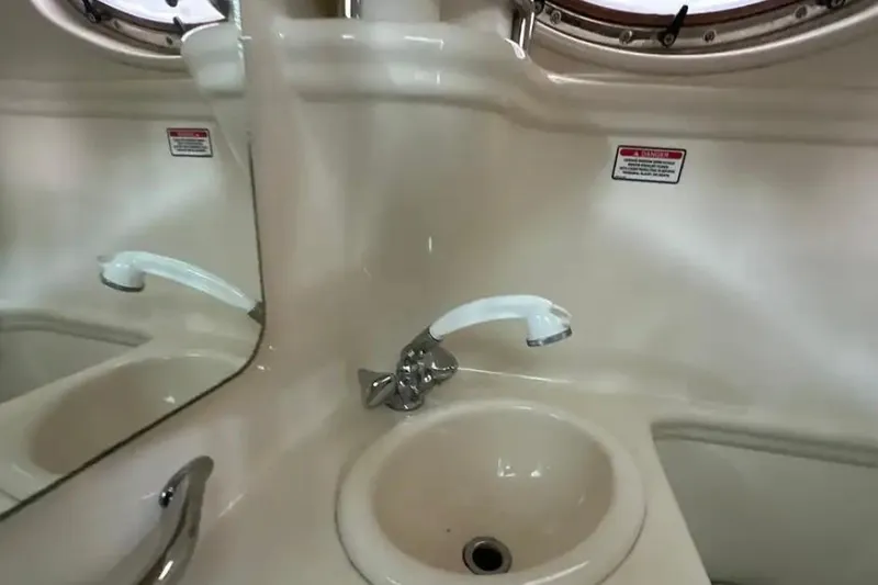 Slide: The Image of 2004 Sea Ray 260 Sundancer bathroom sink with mirror and faucet. - 37