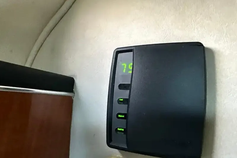 Slide: The Image of Thermostat display inside 2004 Sea Ray 260 Sundancer boat cabin. - 38