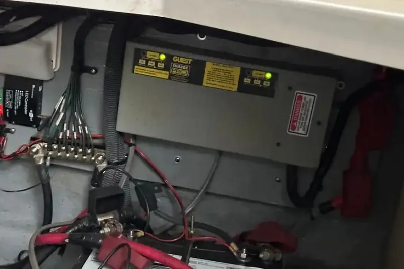 Slide: The Image of Electrical system inside a 2004 Sea Ray 260 Sundancer boat, featuring wiring and battery components. - 43