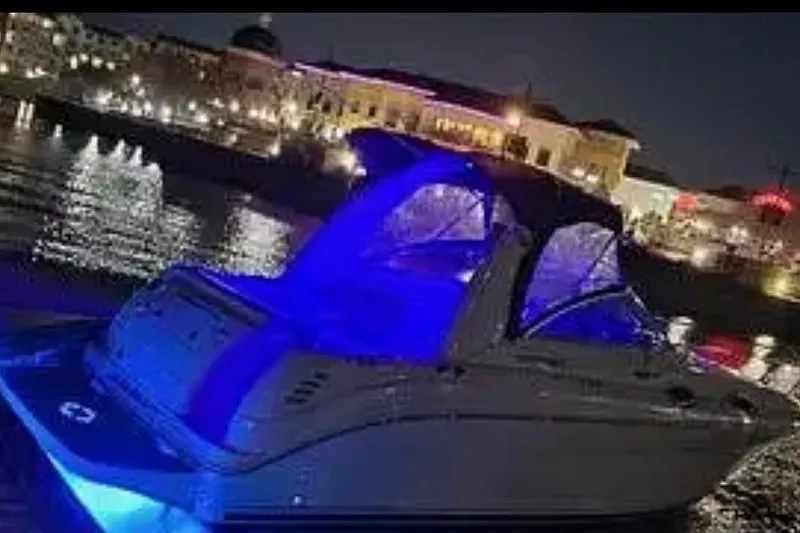 Slide: The Image of 2004 Sea Ray 260 Sundancer with blue lights docked at night. - 45