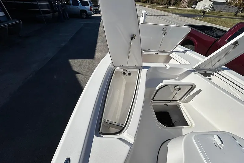 Slide: The Image of 2026 Sea Pro 210 Bay boat with open storage compartments on deck. - 10