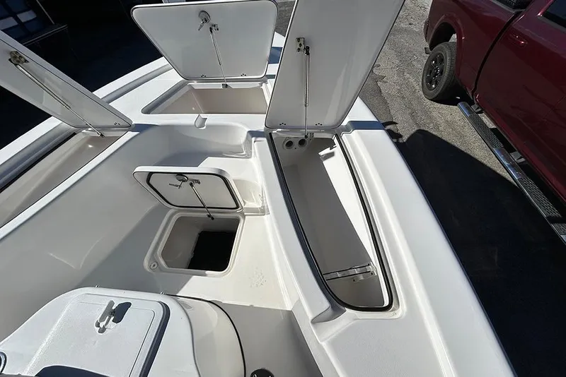Slide: The Image of 2026 Sea Pro 210 Bay boat storage compartments open, showcasing spacious interior design. - 13