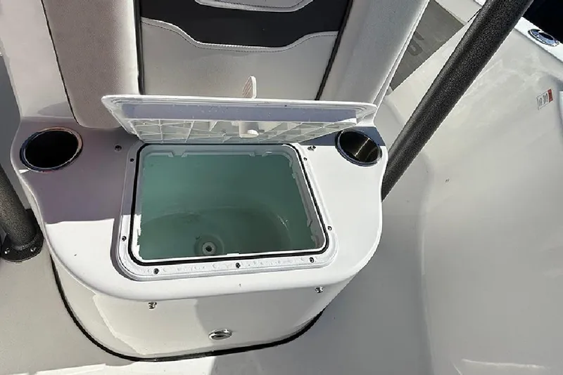 Slide: The Image of 2026 Sea Pro 210 Bay boat with open storage compartment and cup holders. - 14