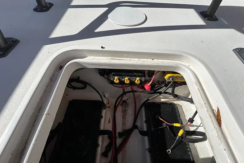 Slide: The Image of 2026 Sea Pro 210 Bay boat battery compartment with wiring and connections. - 25