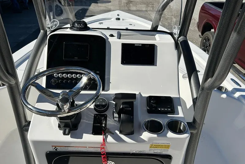 Slide: The Image of 2026 Sea Pro 210 Bay boat console with steering wheel and navigation controls. - 26