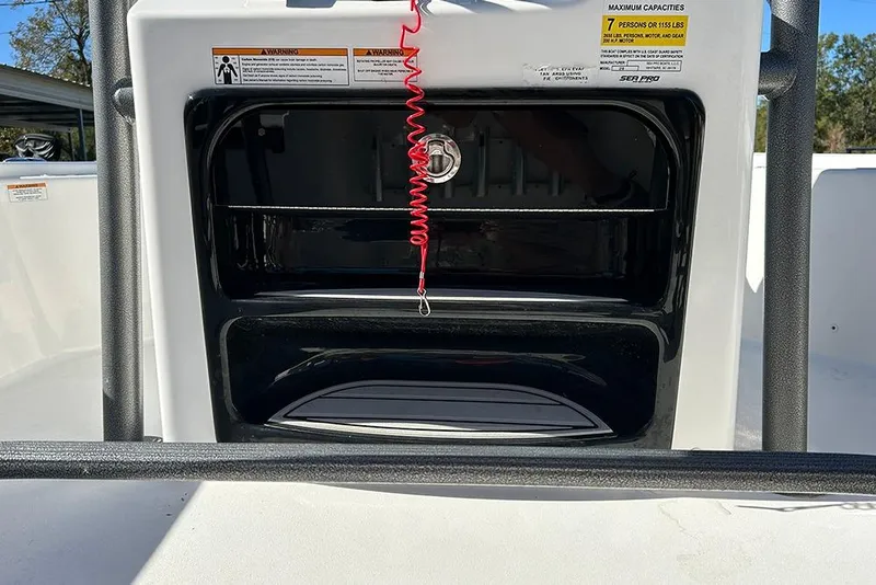 Slide: The Image of 2026 Sea Pro 210 Bay boat console with safety lanyard and capacity warnings. - 31