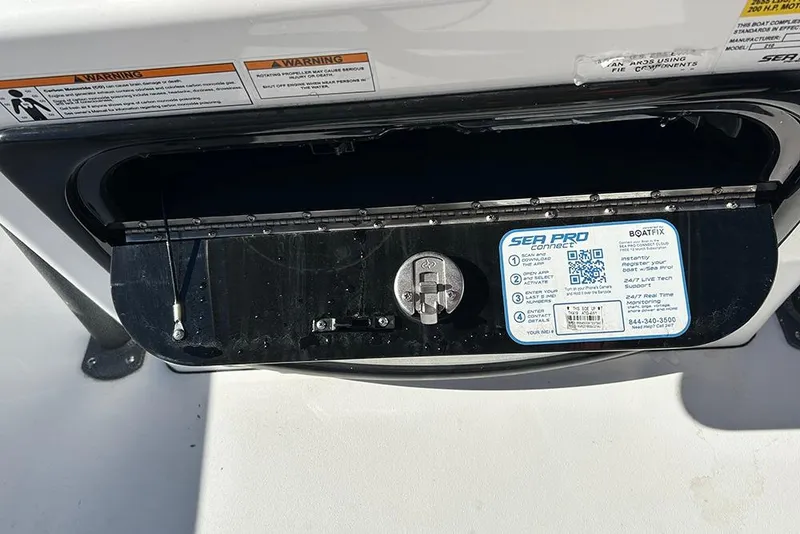 Slide: The Image of Storage compartment on a 2026 Sea Pro 210 Bay boat with safety warnings and Sea Pro Connect instructions. - 32