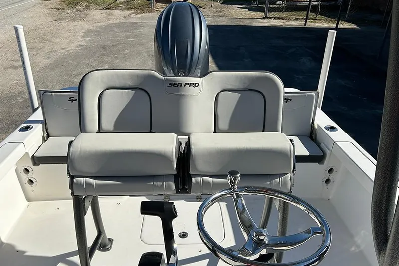 Slide: The Image of 2026 Sea Pro 210 Bay boat interior with steering wheel and seating. - 34